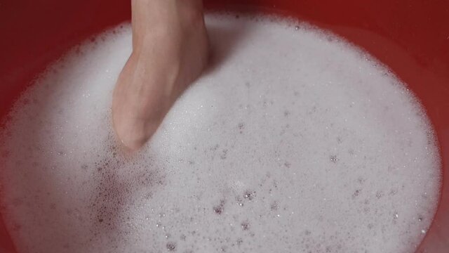 Women soak their fingers in the bath, foam to relax and get ready to cut their nails