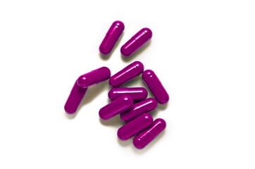 Pink capsule pills isolated on White Background