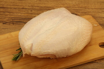 Raw whole chicken breast with skin
