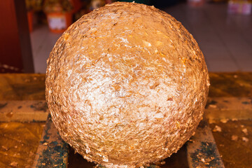 round stones full of Gold leaf, use forburied in the ground to mark the sacred limits of a temple