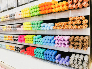 Colorful pens arranged on shelves selling stationery. Office supplies and stationery