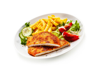 Breaded fried pork chop, French fries and vegetables on white background
