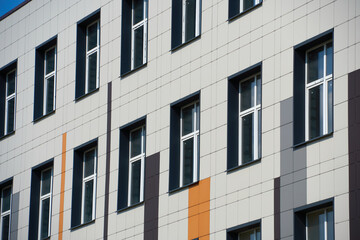 facade of a modern building on a bright Sunny day, siding and Windows, beautiful exterior of the new building