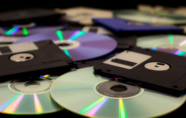 Stack of CDs and Diskettes spread over ground