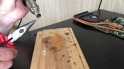 A man melts a wire with a professional blowtorch - Powered by Adobe