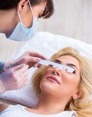 Female ophthalmologist is checking up female patient in eye doct