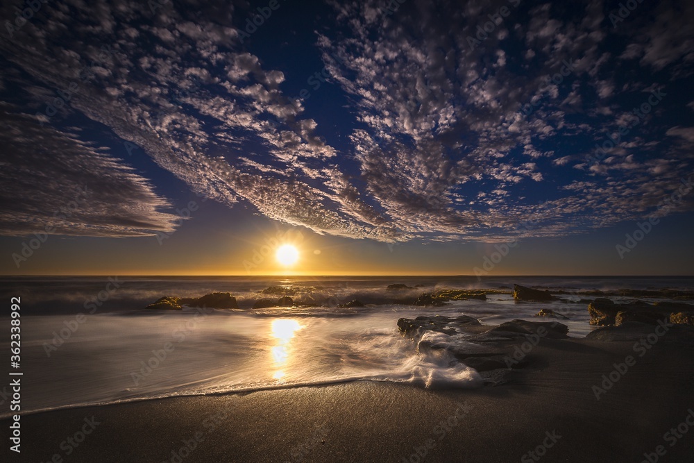 Wall mural beautiful view of a beach with times during the sunset