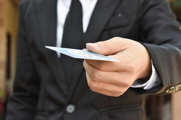 Close-up of businessman hand hold credit card. Selective focus at hands.