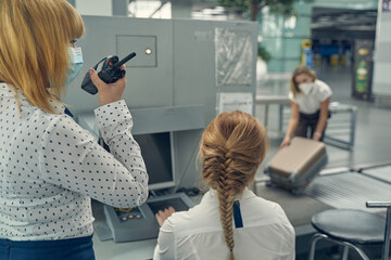 Young female person working with radio set