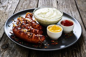 Grilled sausages on wooden board
