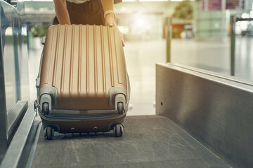 Focused photo on female hand holding suitcase