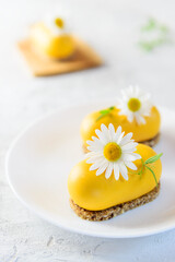 Raw mousse cakes with sea buckthorn on a white plate. No sugar, gluten, lactose.