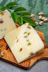 Cheese collection, fresh Italian pecorino cheese made from sheep milk filled with pistachio nuts from Bronte, Sicily