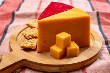 Matured yellow and red waxed cheddar cheese close up