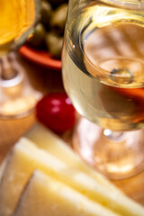 Glasses of dry fino sherry wine served with spanish tapas, manchego cheese, green olives, cheese crackers