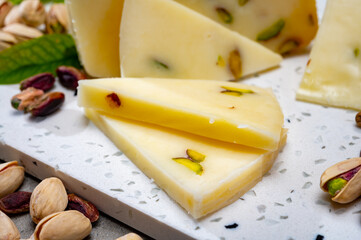 Cheese collection, fresh Italian pecorino cheese made from sheep milk filled with pistachio nuts from Bronte, Sicily