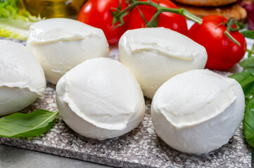 Fresh handmade soft Italian cheese from Campania, white balls of buffalo mozzarella cheese made from cow milk ready to eat