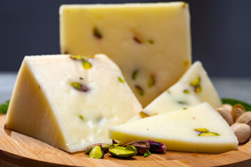 Cheese collection, fresh Italian pecorino cheese made from sheep milk filled with pistachio nuts from Bronte, Sicily