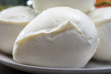 Fresh handmade soft Italian cheese from Campania, white balls of buffalo mozzarella cheese made from cow milk ready to eat