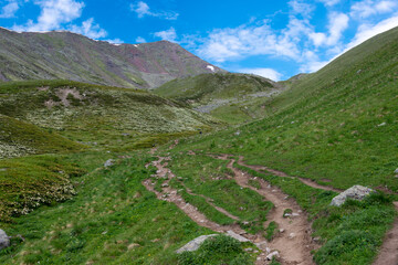 Fototapeta na wymiar Mountain range on a hiking trail from Gergeti Trinity Church to Gergeti Glacier. a famous landscape in Kazbegi, Mtskheta-Mtianeti, Georgia.