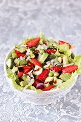 salad with strawberries, avocado, lettuce, onion, green peas. dressed with balsamic sauce.