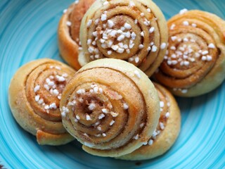 Fototapeta premium OLYMPUS DIGITAL CAMERA Traditonal Swedish cinnamon buns and cardamom buns, made from yeast dough.