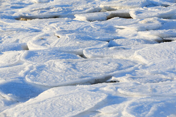 Fototapeta na wymiar Snow after the sea ice, the seaside in winter