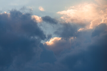 Naklejka na ściany i meble Beautiful rain clouds close-up before sunset. Cumulus clouds close up
