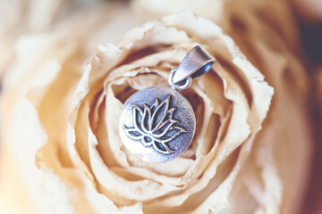 Detail of sterling silver pendant in the shape of lotus in mandala