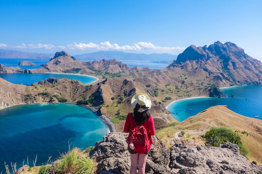 June 14, 2018 - Labuan Bajo, Komodo National Park, Indonesia : Asian girl in red cardigan enjoying view on top of Padar Island.