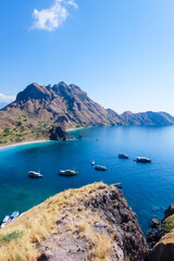 Boats parking near Padar island in the Komodo National Park, Indonesia. As seen from the top of the mountain.