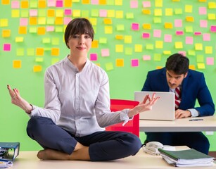 Man and woman in the office with many conflicting priorities in