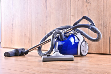 Canister vacuum cleaner for home use on the floor panels