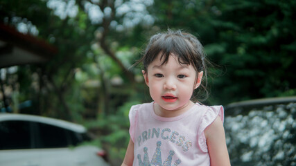 Portrait image of funny asian toddler girl 2-3 years old.