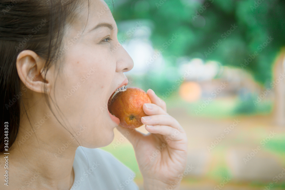 Wall mural close-up asian women eating apple