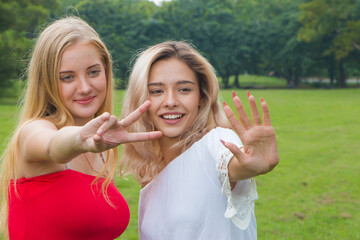 Fototapeta premium Happy young woman and friend are smiling outdoor.