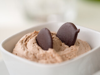 chocolate mousse with chocolate chips in a white bowl