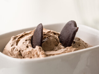 chocolate mousse with chocolate chips in a white bowl