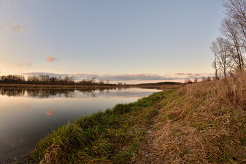 Sunset over a wide river on a cool spring day. Fish eye lens.