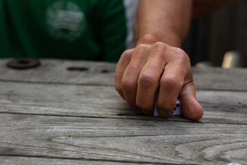 Man grabbing dice from a table