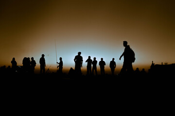 Fototapeta na wymiar group of people at sunset