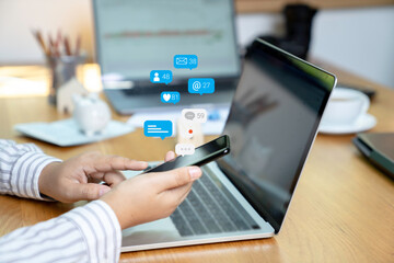 Person using a social media marketing concept on mobile phone with notification icons of like, message, comment and star