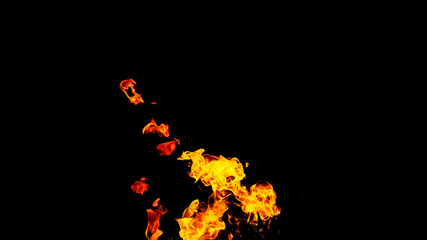 Fire flames on black background isolated. Burning gas or gasoline burns with fire and flames. Flaming burning sparks close-up, fire patterns. Infernal glow of fire in the dark with copy-space