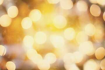 Abstract background of colored blurred orange and golden holiday lights bokeh circles for Halloween or Christmas.