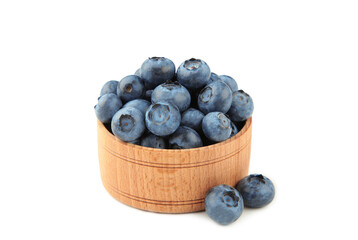 Fresh blueberries in small wooden bowl isolated on white background