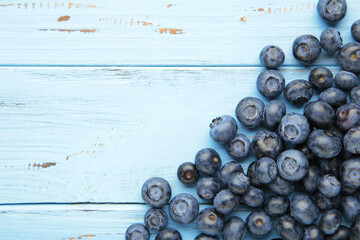 Tasty blueberries on blue background with copy space. Blueberries are antioxidant organic superfood.