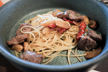 Stir-fried spaghetti with dried chili and beef.