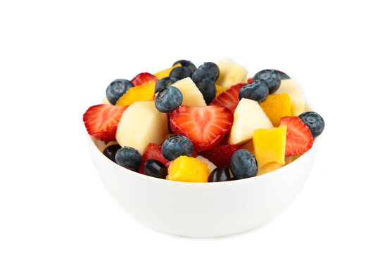Fresh fruit salad in white bowl isolated on white background