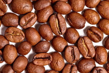 Tasty coffee beans with appetizing warm lighting for detail structure and depth on a white background 