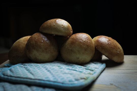 Freshly Baked Buns on a wooden table. 